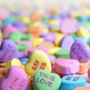 Conversation Heart candies piled on top of one another.